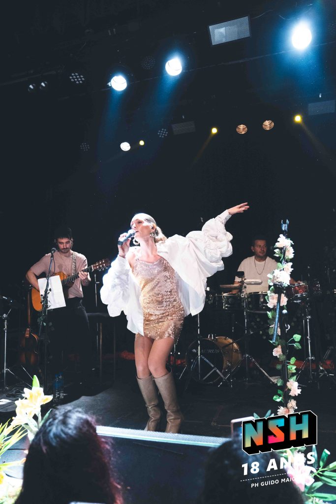 Rocío Igarzábal interpretando canciones de Volare en vivo en La Tangente
Escena del show de Rocío Igarzábal con vestuario etéreo durante Volare
El público emocionado en el recital de Rocío Igarzábal en Buenos Aires
Dueto entre Rocío Igarzábal y El Purre en La Tangente
Cambio de vestuario de Rocío Igarzábal en su presentación de Volare
Potra y Rocío Igarzábal en una interpretación íntima durante el show
Vista del escenario iluminado durante el concierto de Volare en La Tangente
Rocío Igarzábal celebrando con el público al final de su show en vivo
Momentos festivos del recital de Rocío Igarzábal con coreografía y luces
Detalle del EP Volare presentado por Rocío Igarzábal en La Tangente