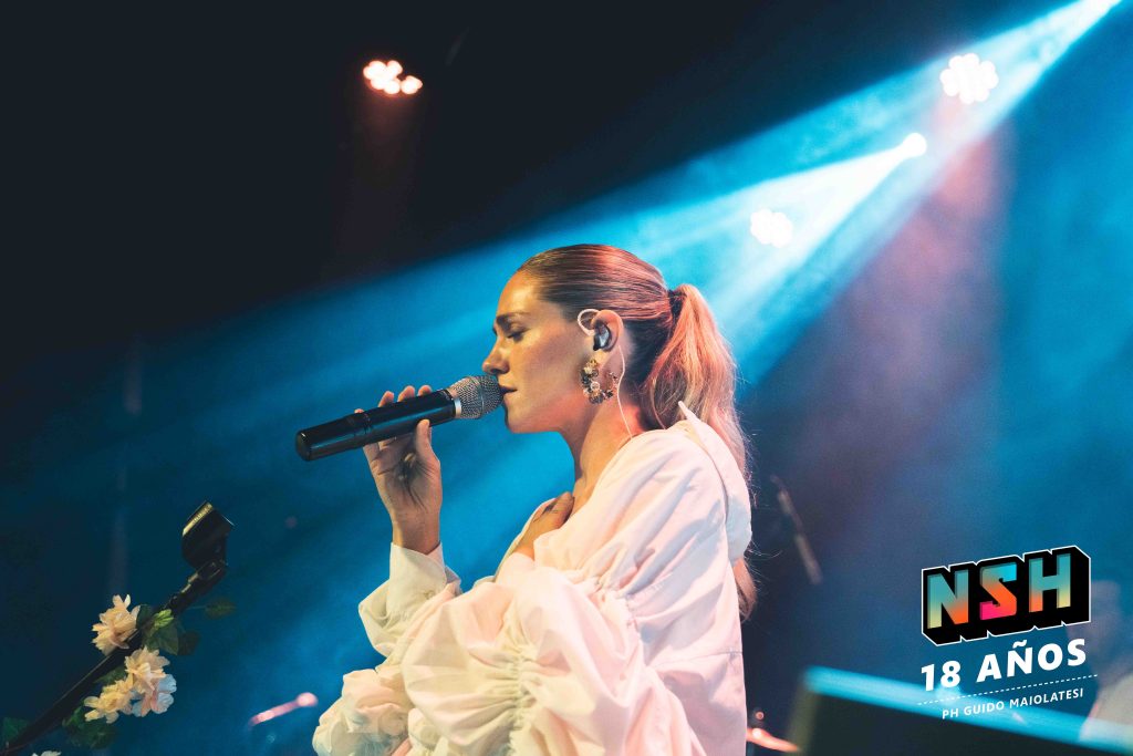 Rocío Igarzábal interpretando canciones de Volare en vivo en La Tangente
Escena del show de Rocío Igarzábal con vestuario etéreo durante Volare
El público emocionado en el recital de Rocío Igarzábal en Buenos Aires
Dueto entre Rocío Igarzábal y El Purre en La Tangente
Cambio de vestuario de Rocío Igarzábal en su presentación de Volare
Potra y Rocío Igarzábal en una interpretación íntima durante el show
Vista del escenario iluminado durante el concierto de Volare en La Tangente
Rocío Igarzábal celebrando con el público al final de su show en vivo
Momentos festivos del recital de Rocío Igarzábal con coreografía y luces
Detalle del EP Volare presentado por Rocío Igarzábal en La Tangente